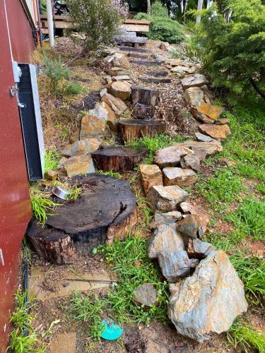 a garden with rocks and a stone path at Funday Farm Adelaide Hills in Norton Summit