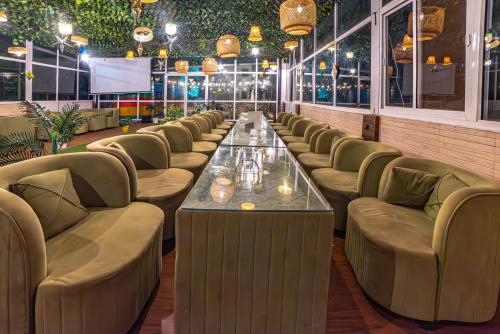 a row of couches and a table in a restaurant at The Bunkk Inn Hotel & Restaurant - Mussoorie International in Mussoorie