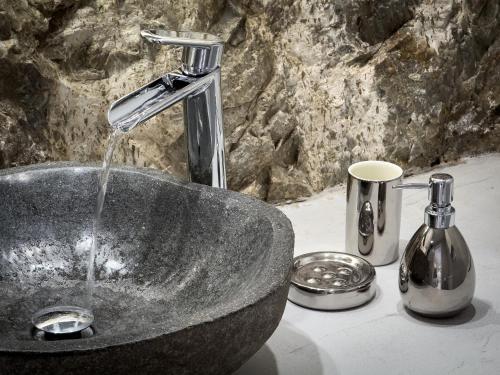 a sink with water running from a faucet at Garbis in Karavostasi