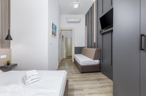 a small room with a bed and a couch at Boutique Suites Joyce in Pula