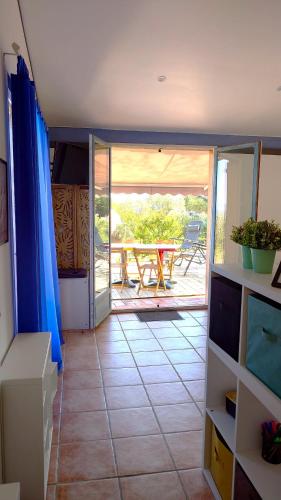 a view of a room with a table and a patio at LOFT L'Olivier in Llauro