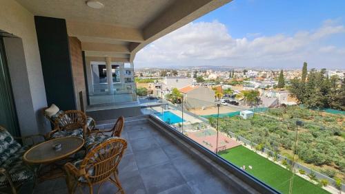 a balcony with a table and chairs and a view at Suburban Escape in Limassol