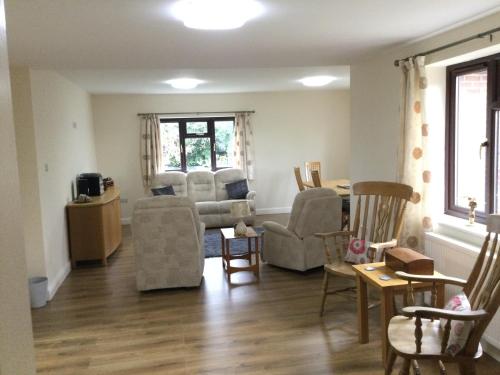 a living room with a couch and chairs at Applewood in South Wheatley