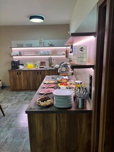 a kitchen with a counter with plates of food at Penzion Rožmberk in Třeboň