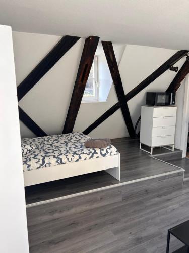 a bedroom with a bed and a white dresser at STRASBOURG : STUDIO HYPER CENTRE in Strasbourg