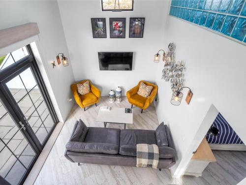 an overhead view of a living room with a couch and chairs at Ocean Mist in Carna