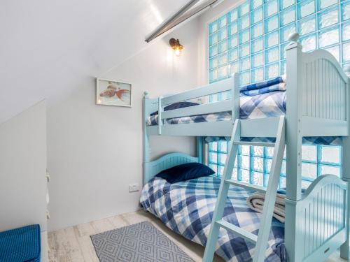 a bunk bed room with two bunk beds and a ladder at Ocean Mist in Carna