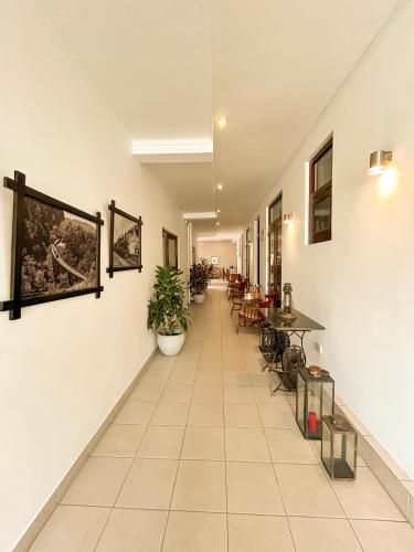 a hallway with tables and chairs in a building at Maria Villa by Blue Bird in Negombo