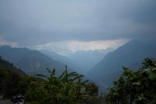a view of a valley with mountains in the distance at LA Riqueza Sushanti Retreat - Mountain View Rooms with Balcony # Pure Veg Restaurant # Jain Food Available # Parking # Customer's choice Hotel in Gupta Kāshi