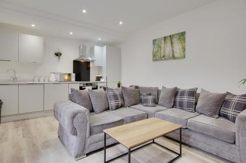 a living room with a couch and a kitchen at Wimborne Road Apartment 4 in Bournemouth