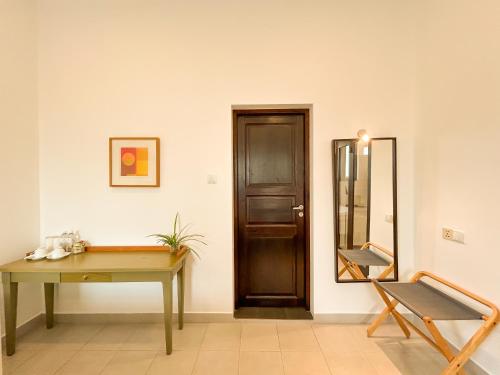 a room with a wooden table and a mirror at Maria Villa by Blue Bird in Negombo