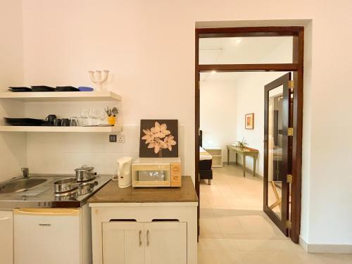 a kitchen with a counter with a microwave on it at Maria Villa by Blue Bird in Negombo