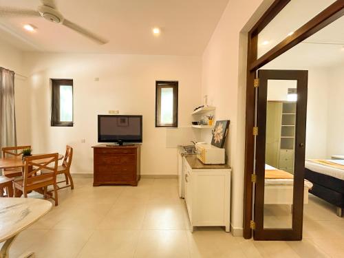 a living room with a television and a dining room at Maria Villa by Blue Bird in Negombo