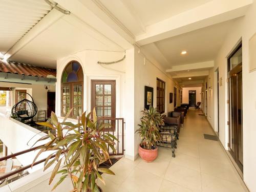an open hallway of a house with plants at Maria Villa by Blue Bird in Negombo