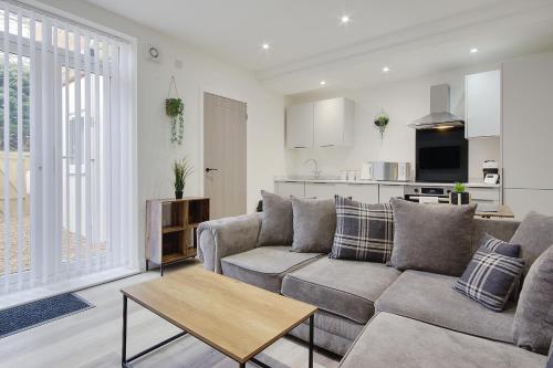 a living room with a couch and a table at Wimborne Road Apartment 4 in Bournemouth