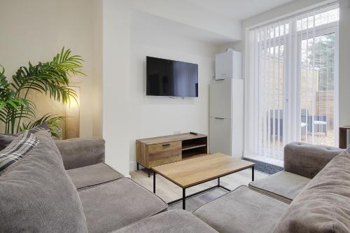 a living room with a couch and a tv at Wimborne Road Apartment 4 in Bournemouth