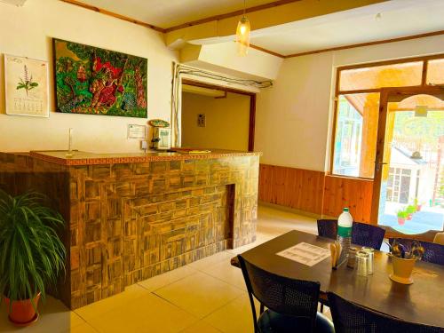 a bar in a restaurant with a table and chairs at Hotel The Premium Villa Manali View in Manāli