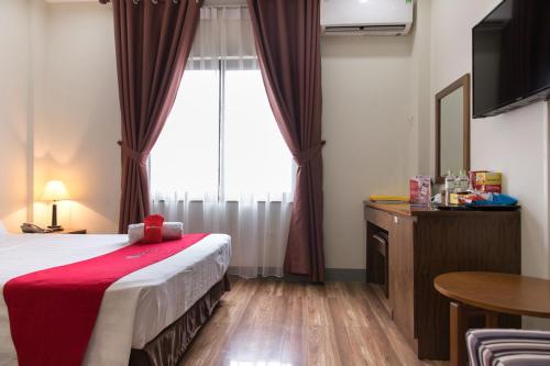 a hotel room with a bed and a window at Mai Hotel My Dinh 미딩 in Hanoi