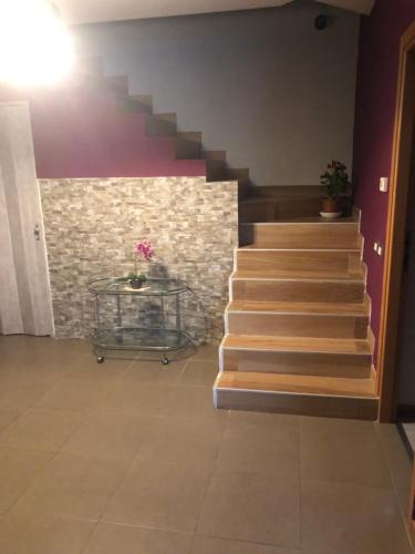 a staircase in a building with a stone wall at Casa ORCHIDEA in Bertonico