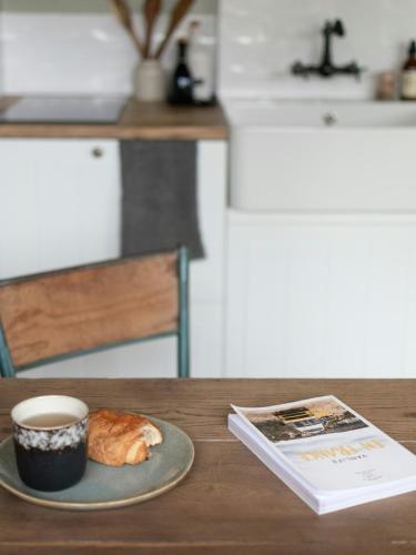 a cup of coffee and a croissant on a table at Peaceful Refuge In Burgundy Near Beaune in Champignolles