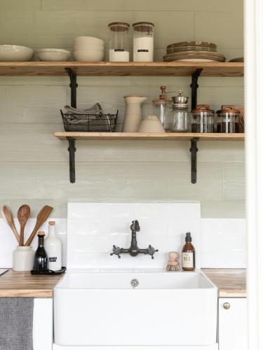 a kitchen counter with a sink and shelves at Peaceful Refuge In Burgundy Near Beaune in Champignolles