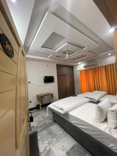 a bedroom with a large bed in a room at Aban Suites in Dargai