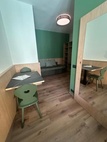 a room with a table and a chair and a mirror at Agritur Leita in Tuenno