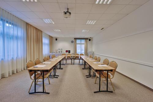 a conference room with wooden tables and chairs at Penzion Drak in Liptovský Mikuláš