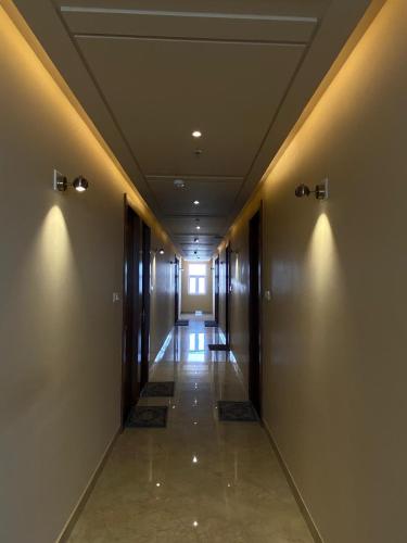 an empty hallway with lights on the walls of a building at Hotel Virat Inn in Bikaner
