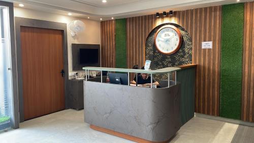 an office lobby with a large clock on the wall at Hotel Virat Inn in Bikaner
