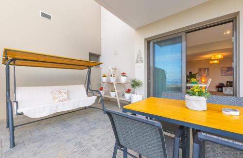 a room with a bed and a table and chairs at Villa Kos View 1 in Platánion