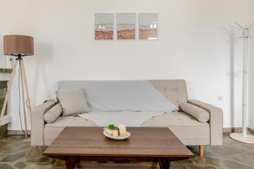 a living room with a couch and a coffee table at Harmony Apartment 2 in Agios Sostis