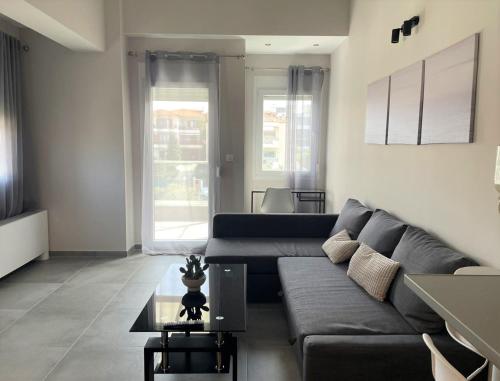 a living room with a couch and a table at Panorama Sunvilles Apartment 5 in Thessaloniki
