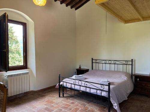 a bedroom with a bed in a room with a window at Ca' Vamperti in Cigliano