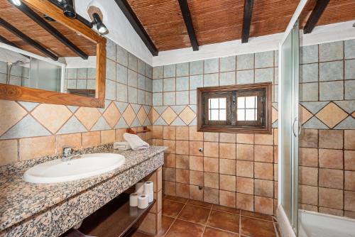 a bathroom with a sink and a mirror at El Pajar in Málaga