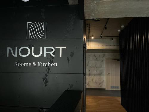 a sign that says nunit on a wall in a building at Nourt Rooms & Kitchen in Karpacz
