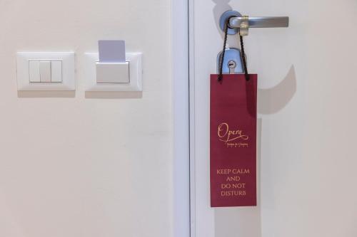 a door with a red tag hanging from it at Opera Relais De Charme - Aparthotel in Verona