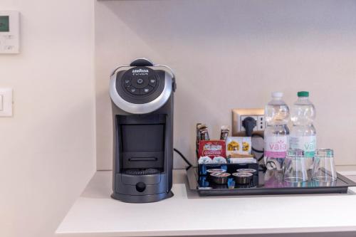 a coffee maker sitting on top of a counter at Opera Relais De Charme - Aparthotel in Verona