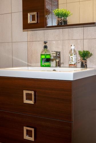 a bathroom counter with a sink and a mirror at Sunset's Nest by Golden Host in Flogita