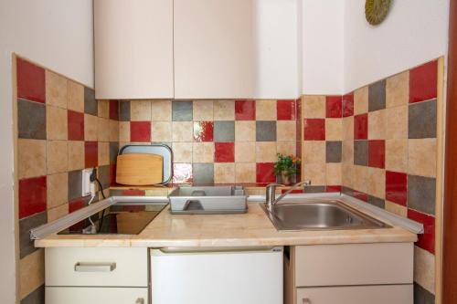 a kitchen with a sink and a counter top at Apartments MaXhit in Tivat