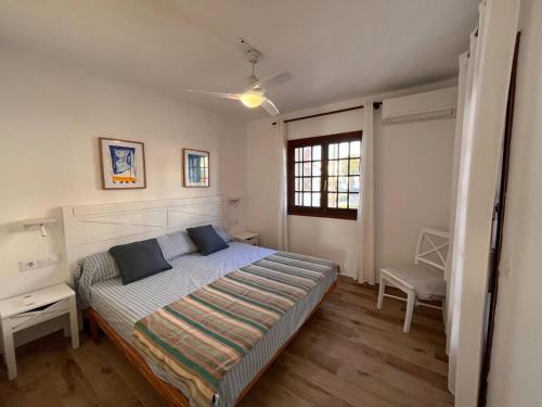 a bedroom with a large bed and a window at Apartamento La Gavina in Son Bou