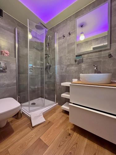a bathroom with a shower and a sink at Apartament "Love Heaven" Jacuzzi SPA z dużą wanną z hydromasażem dla Dwojga in Gniezno