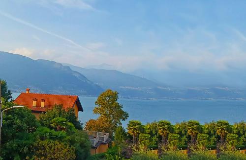 a house with a view of a lake and mountains at Casa Bianca, Vista unica sul lago di Como in Dervio
