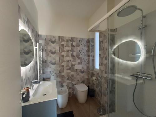 a bathroom with a shower and a sink and a toilet at Casa Bianca, Vista unica sul lago di Como in Dervio