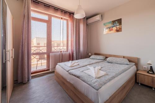 Ένα ή περισσότερα κρεβάτια σε δωμάτιο στο Holiday Apart 1