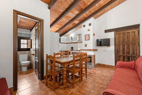 a kitchen and dining room with a table and chairs at El Granero in Málaga