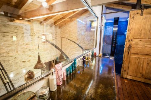 une cuisine avec un comptoir et un évier dans une pièce dans l'établissement 13Th Century Cévennes Farmhouse With Natural Pool, à Soustelle