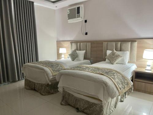 Ένα ή περισσότερα κρεβάτια σε δωμάτιο στο Burj Al Hayat Furnished Apartment 2 - Abu Arish