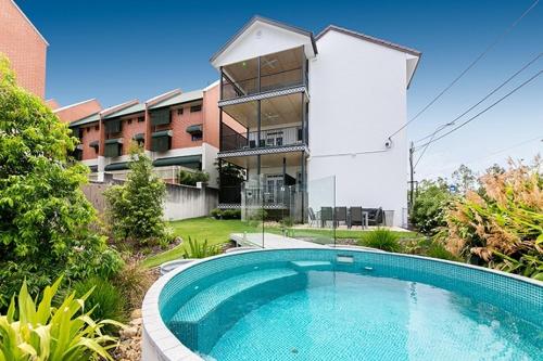 a large swimming pool in front of a building at The Carrington Manor in Brisbane