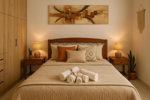 a bedroom with a bed with two pairs of slippers at Lion house Vrachati in Vrachati